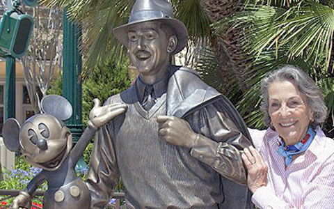 Diane Disney by Statue of Walt Disney and Mickey