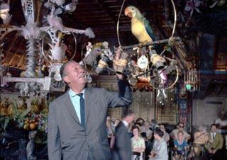 Walt in the Tiki Room with an animatronics parrot