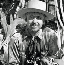 John W. Hilton with camera, bolo tie and white hat