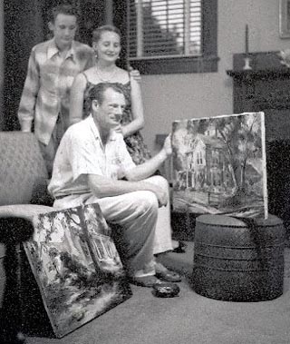 Joshua Meador with paintings of Columbus, Mississippi