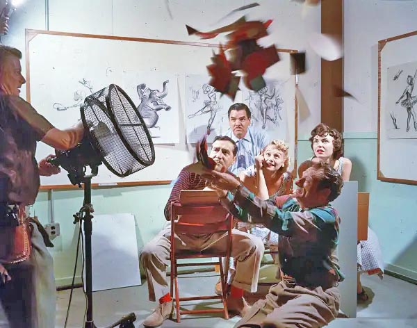 Joshua Meador feeds leaves into an air stream as Disney Artists sketch, catching leaves in motion.  Mary Blair is the artist seated in the center.